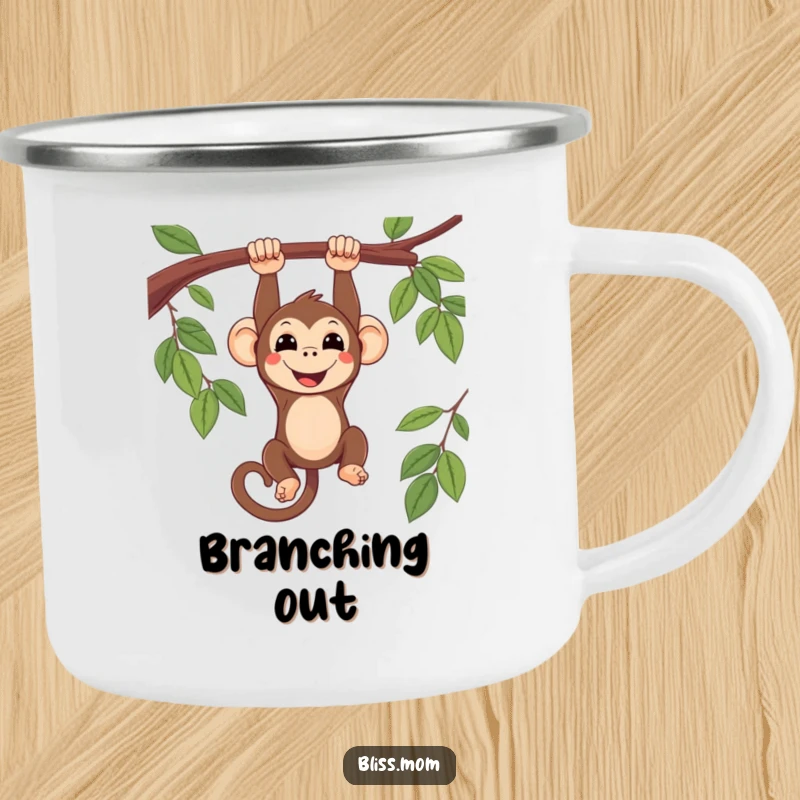 Funny smiling kawaii monkey hanging upside down from a branch, on a rugged camping mug, perfect for adventurous sipping.