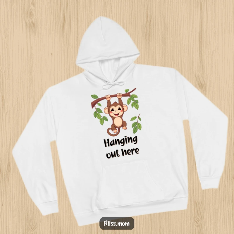 Funny smiling kawaii monkey hanging upside down from a branch, printed on a warm, comfortable hoodie, radiating chill vibes.