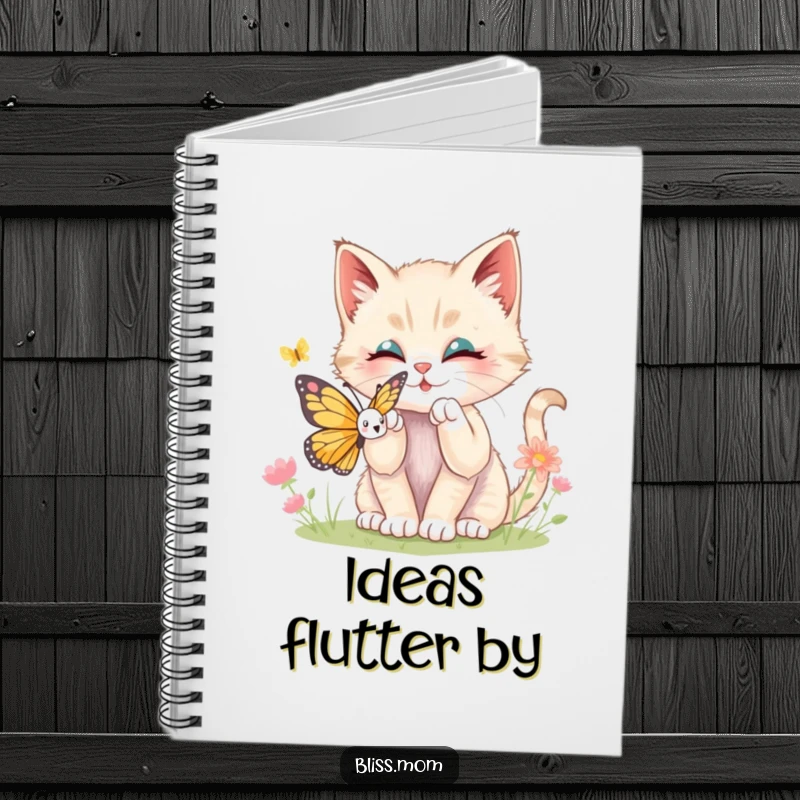 Funny kawaii kitten batting playfully at a butterfly, featured on a notebook cover, inspiring creative thoughts and joyful notes.