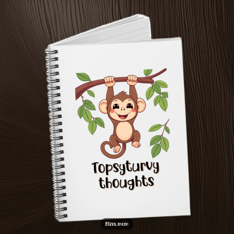 Funny smiling kawaii monkey hanging upside down from a branch, on a notebook cover, inspiring playful thoughts and creative notes.
