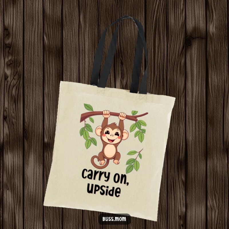 Funny smiling kawaii monkey hanging upside down from a branch, on a durable tote bag, adding a playful touch.