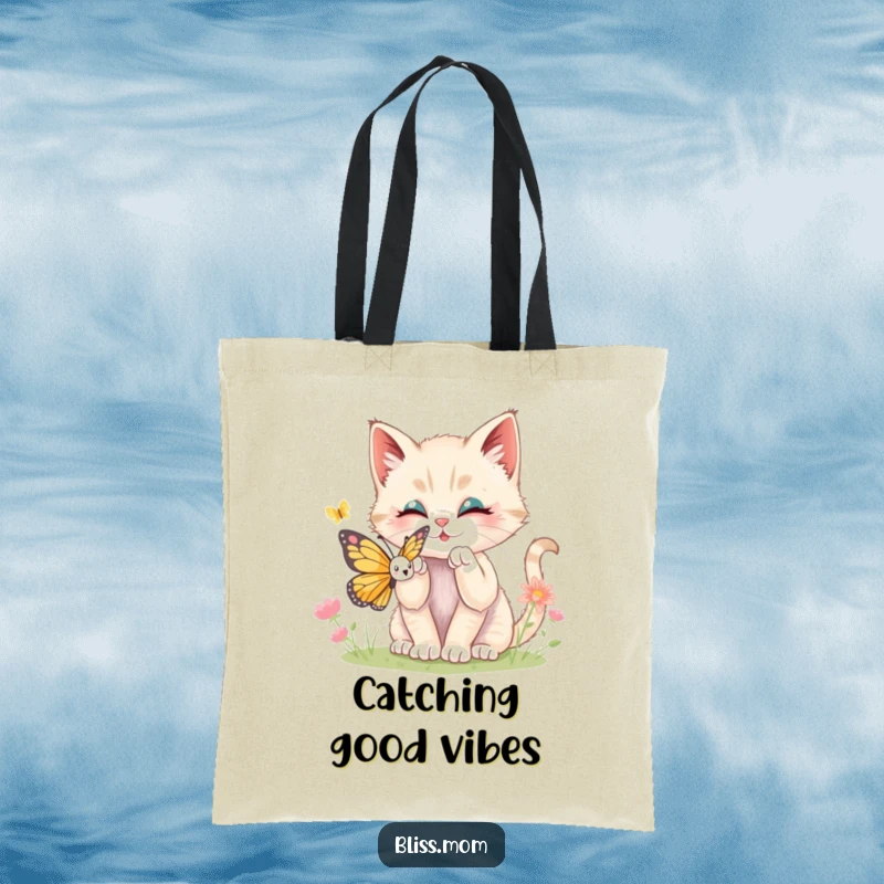 Funny kawaii kitten playfully batting at a butterfly, depicted on a durable tote bag, showcasing a sweet, lighthearted moment.